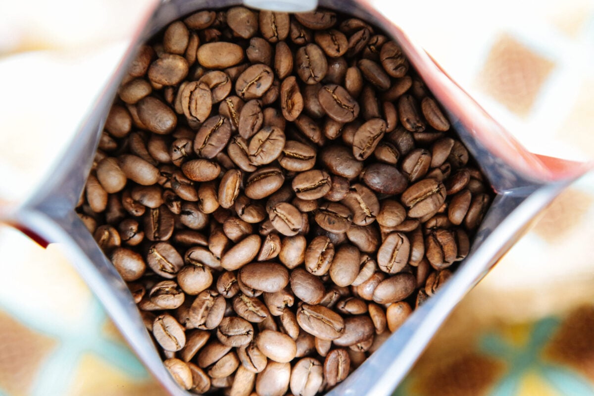 Bolsa abierta demostrando los granos de café tostado de Finca La Perla